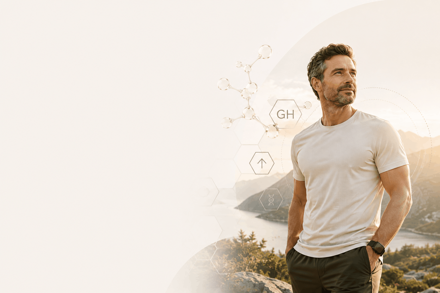 Man outdoors beside a lake and mountains.